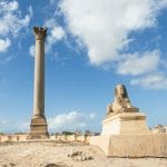 the famous pompey pillar with sphinx in the upper egyptian city of alexandria